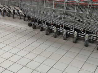 a row of empty shopping carts in a store
