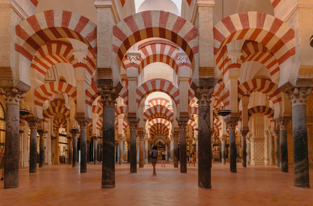 a large building with columns and arches in it