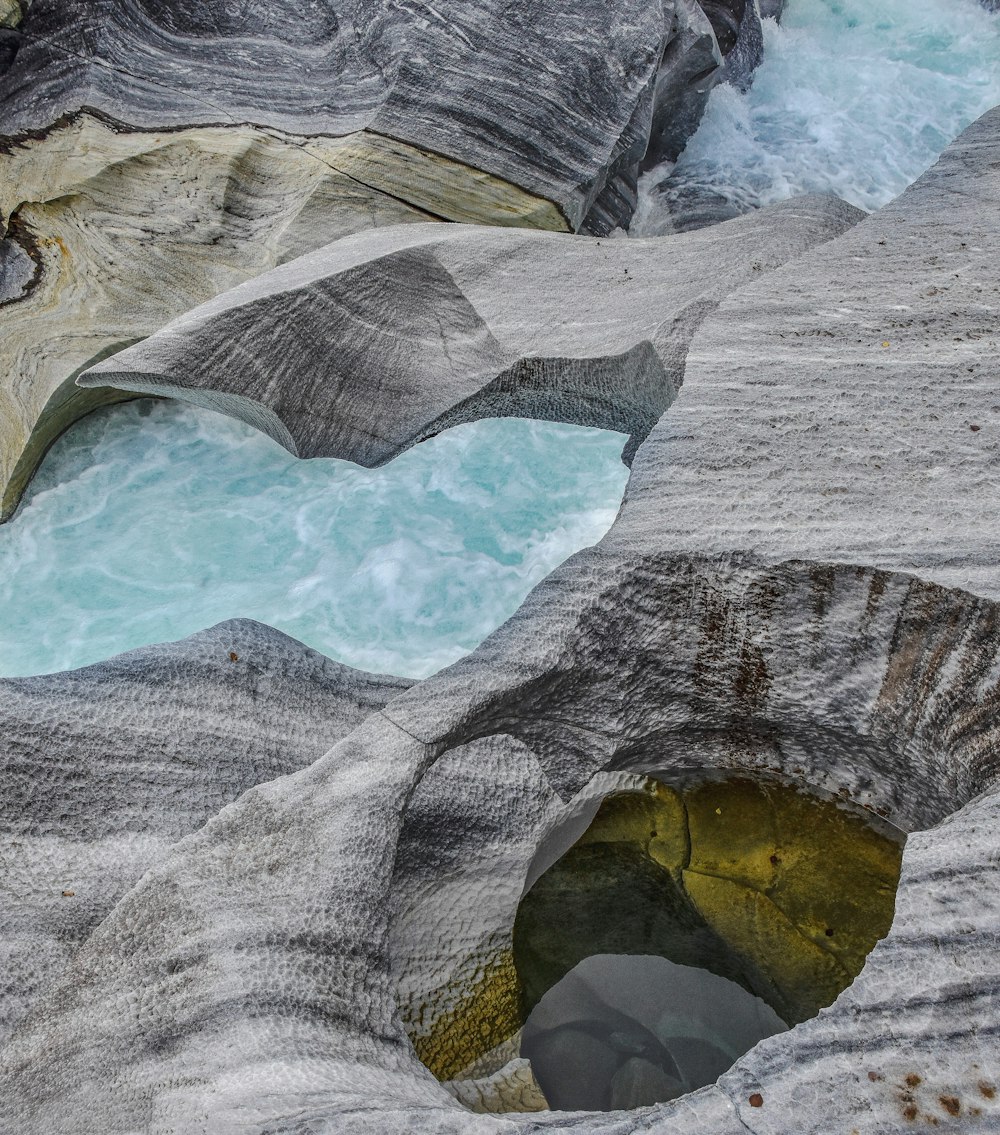 a large rock formation with a pool of water in it