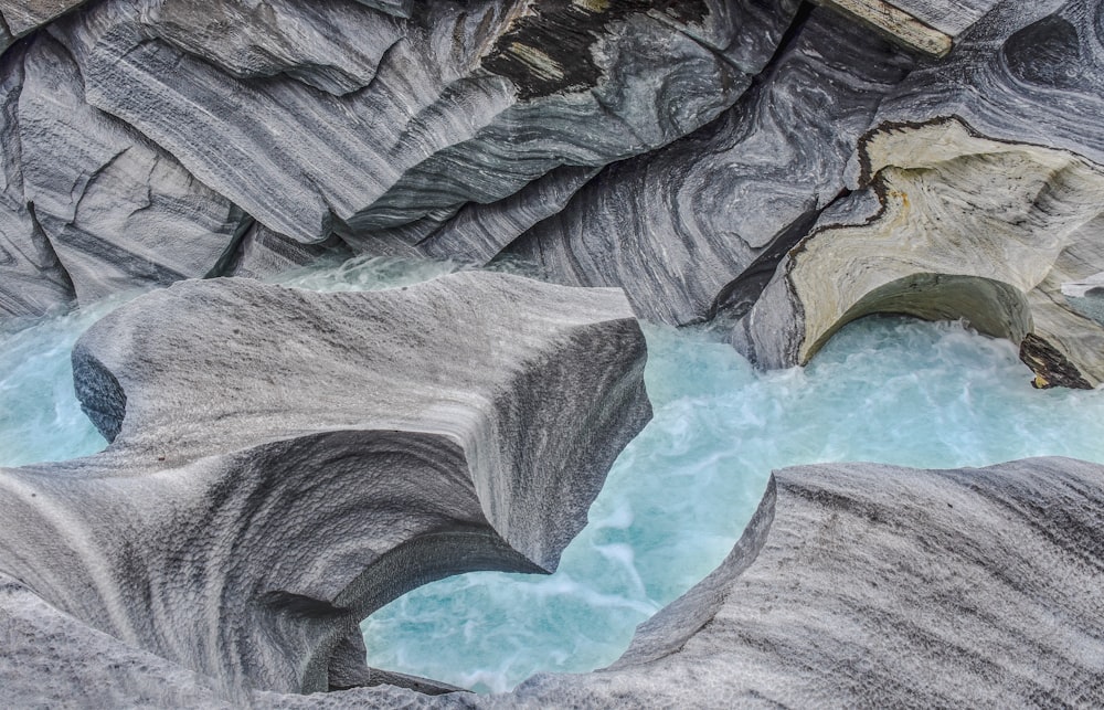 a river flowing through a canyon next to a cliff