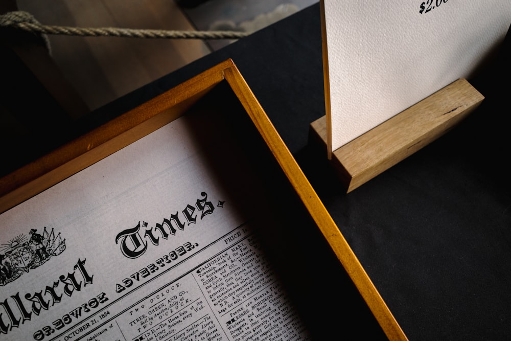 a wooden box with a newspaper inside of it