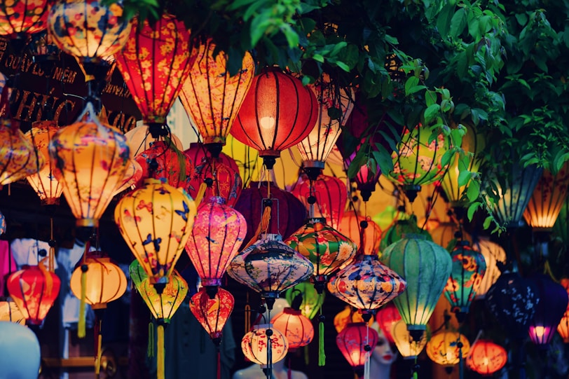 Hanoi or Ho Chi Minh City? a bunch of lanterns that are hanging from a tree