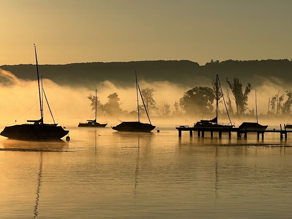 a group of boats floating on top of a lake