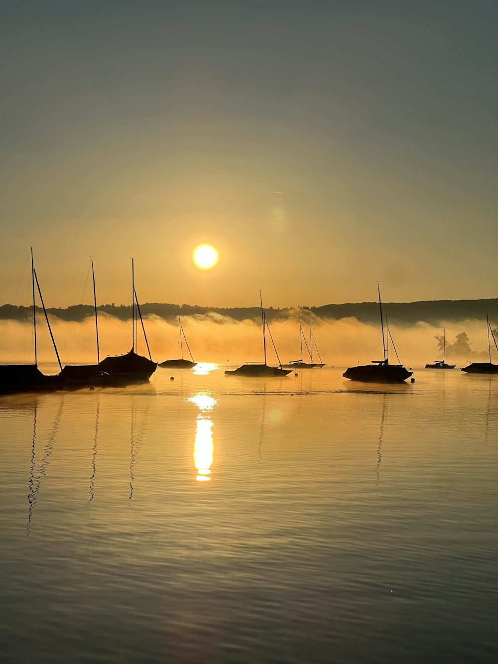 a group of boats floating on top of a lake