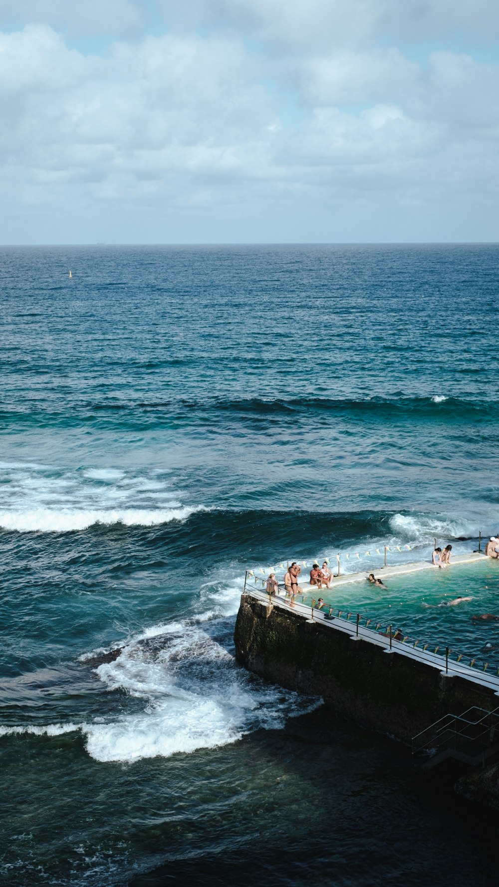 a group of people swimming in the ocean