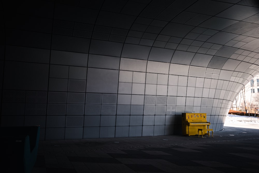 a yellow bench sitting in the middle of a tunnel