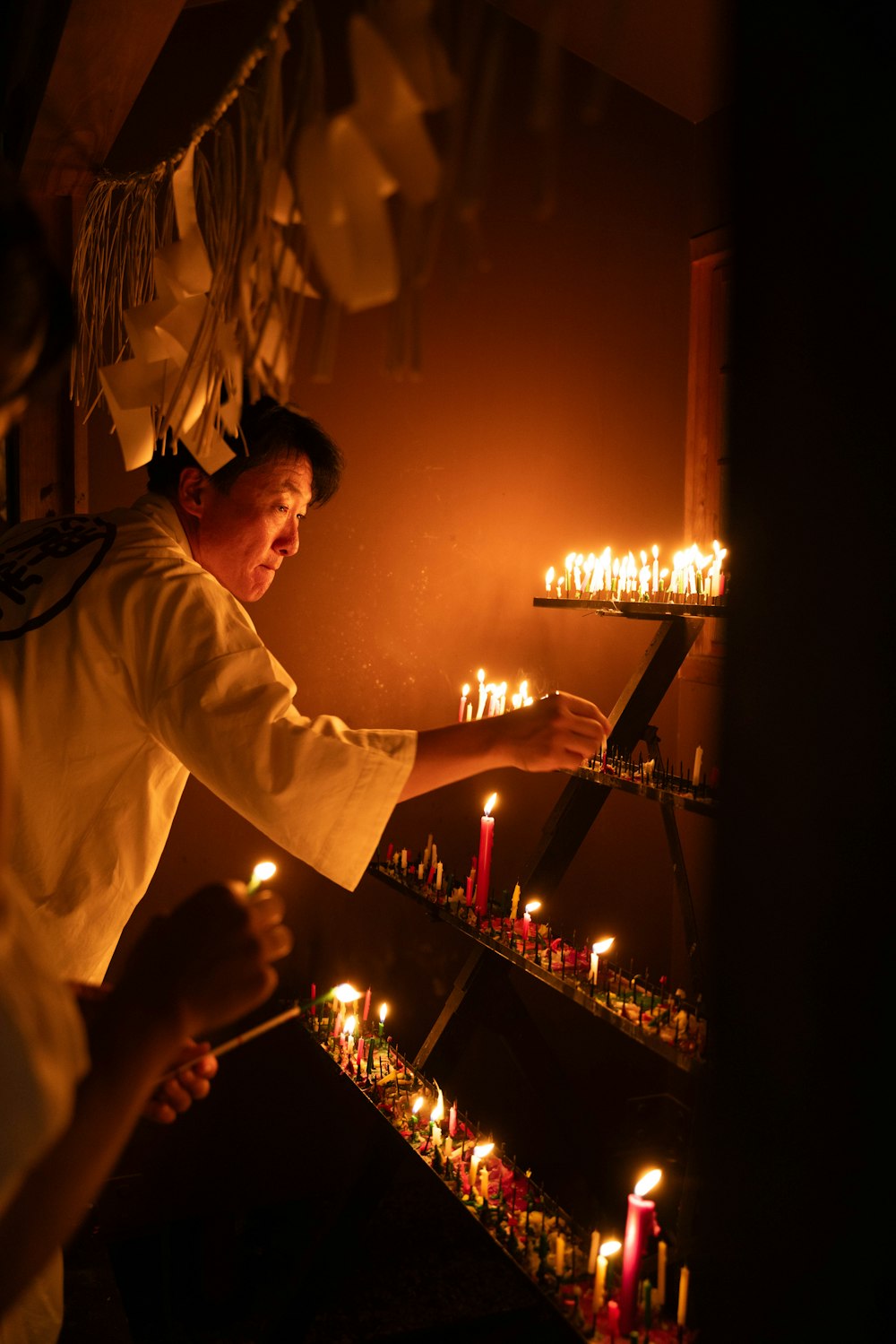 a person lighting candles in a room