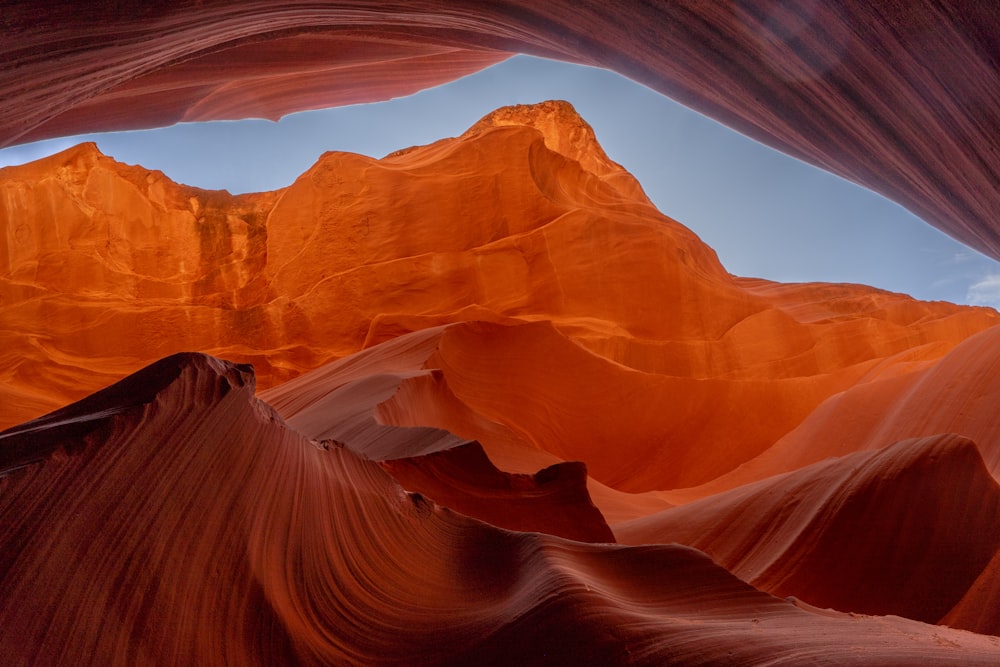 a view of a desert with a mountain in the background