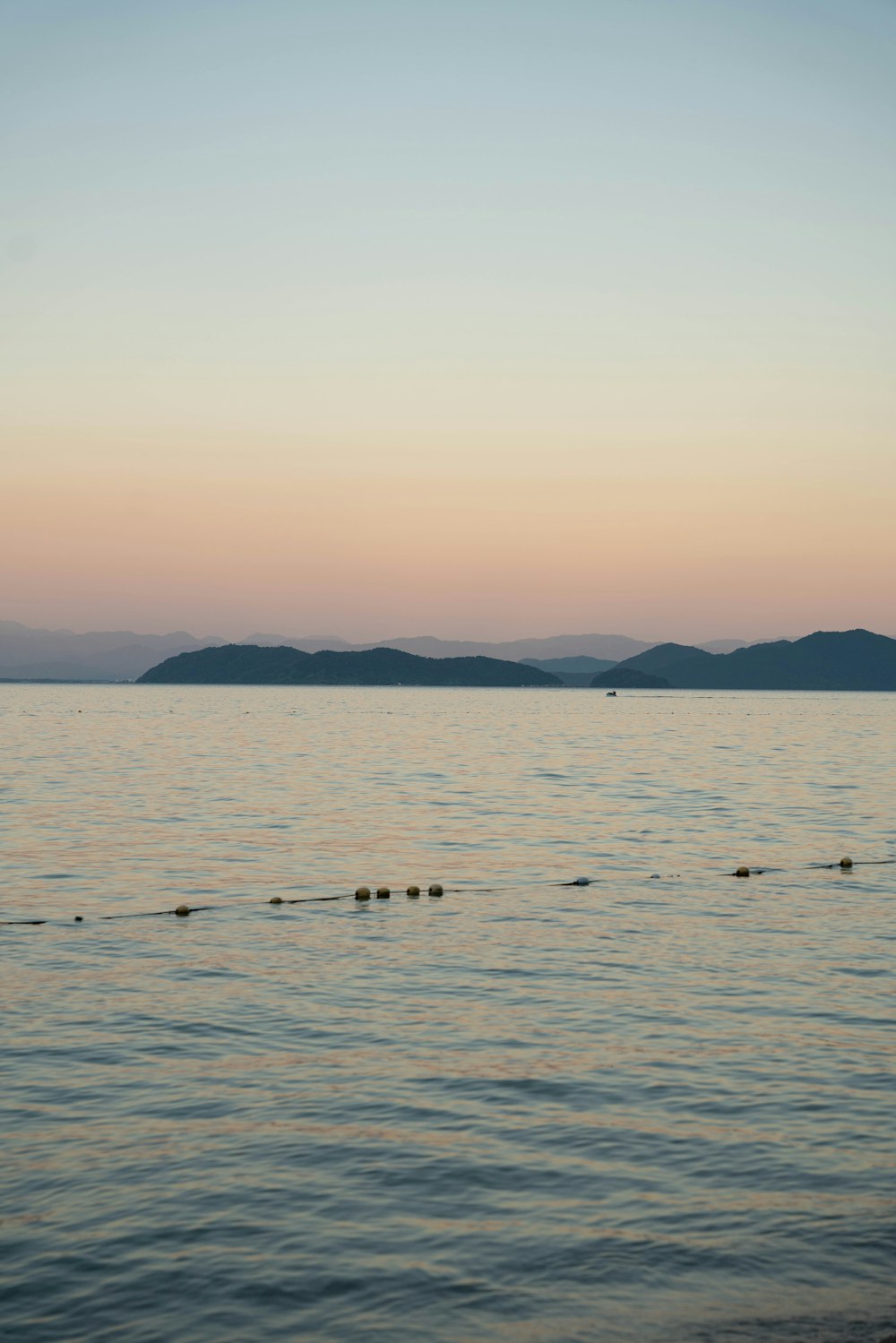 a large body of water with mountains in the background