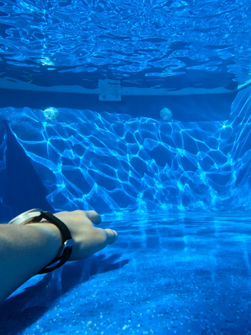 a person laying down in a pool of water
