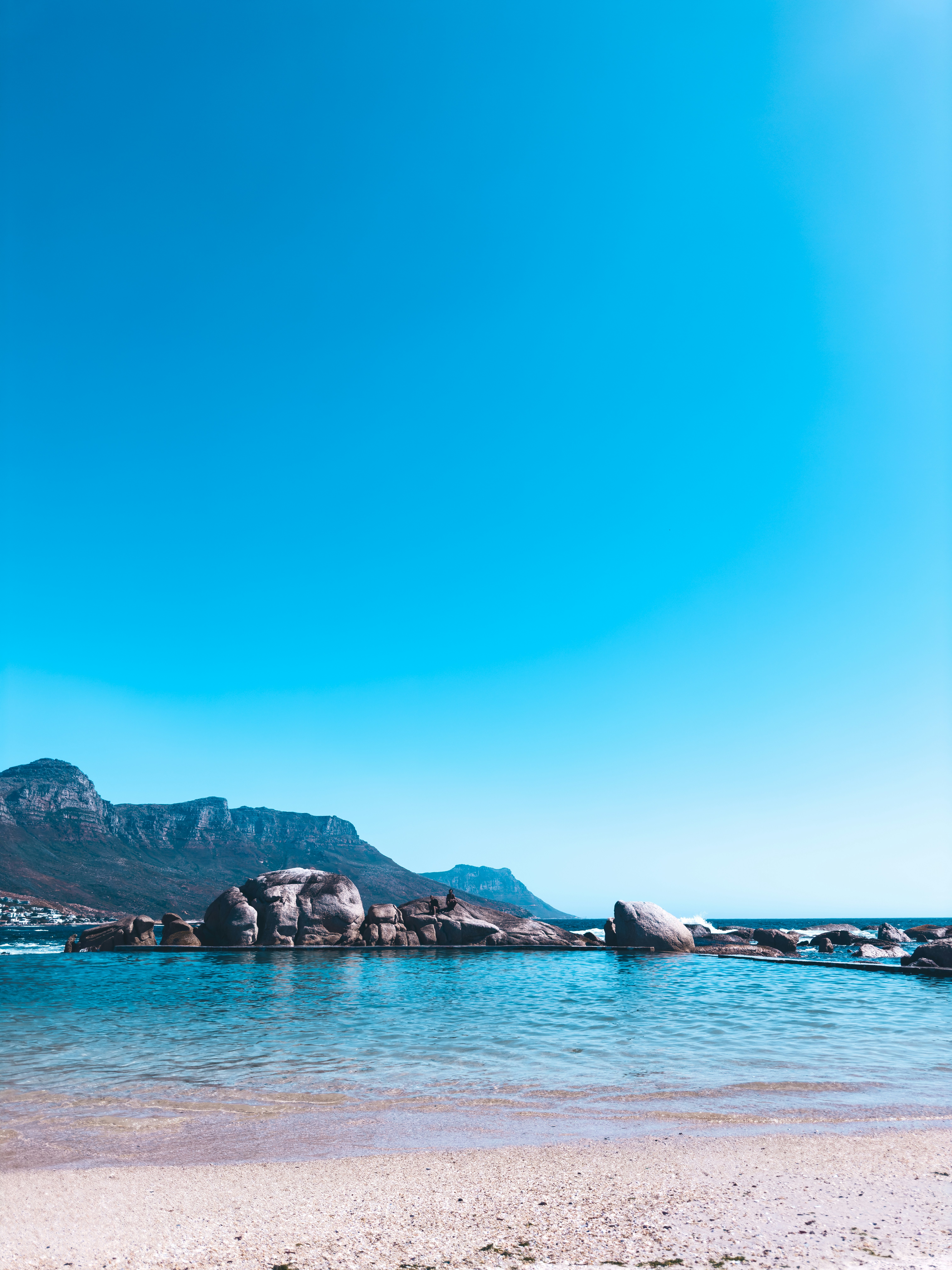 a beach with a mountain in the background