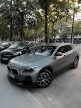 Dark gray city street with a yellow car driving calmly.