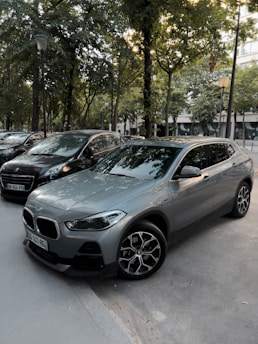 Dark gray city street with a yellow car driving calmly.
