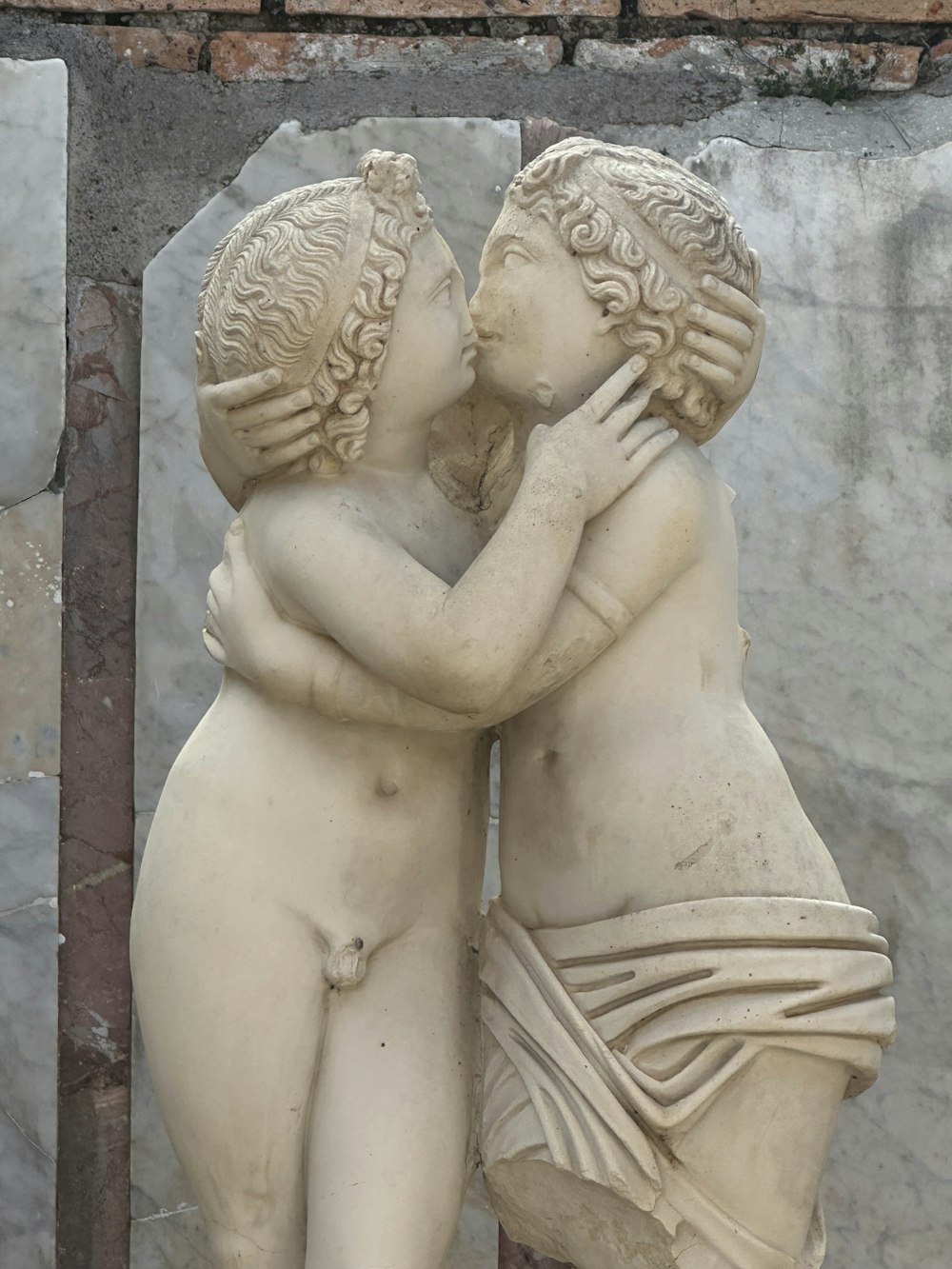 a statue of two women embracing each other