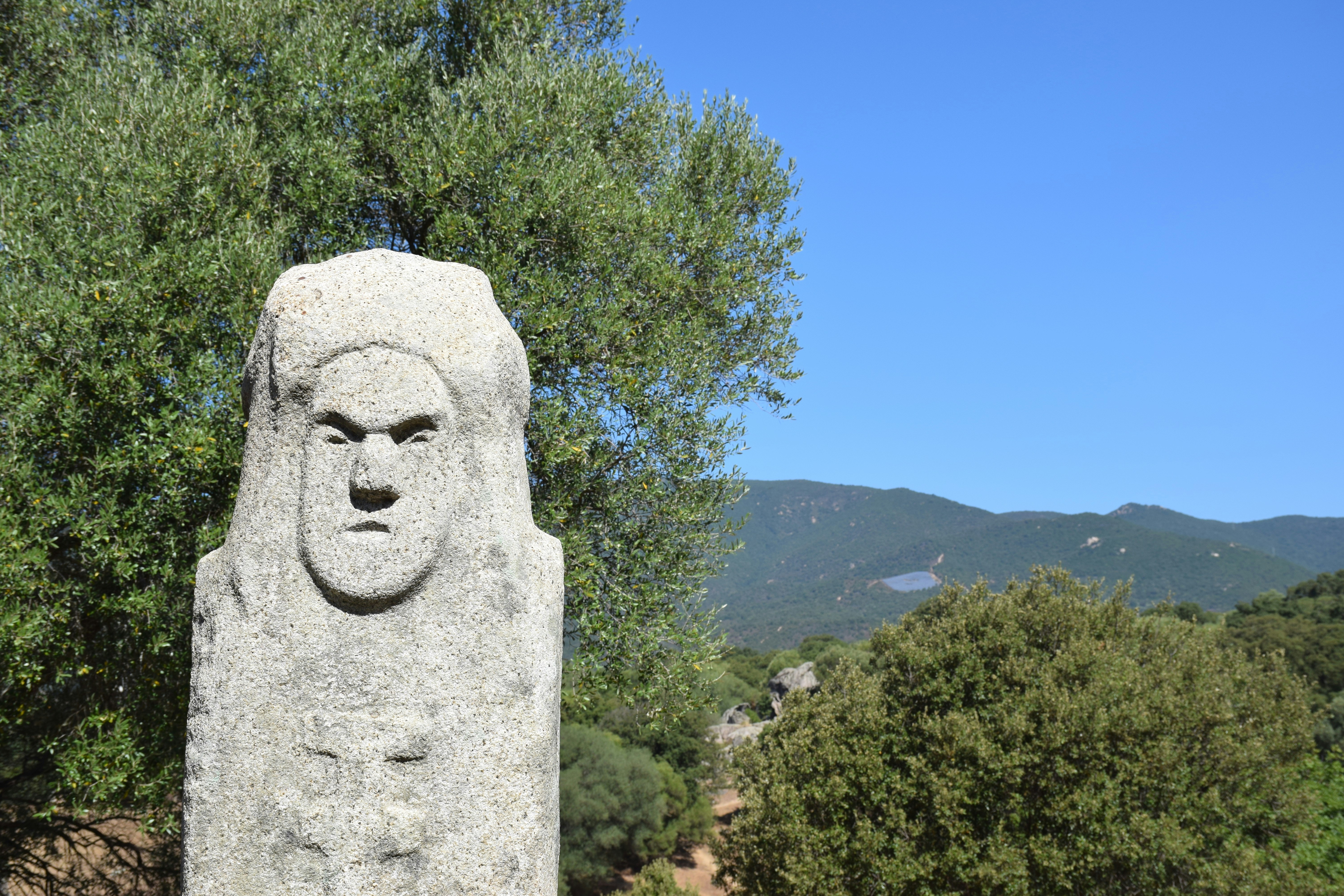 a stone statue of a man with a beard