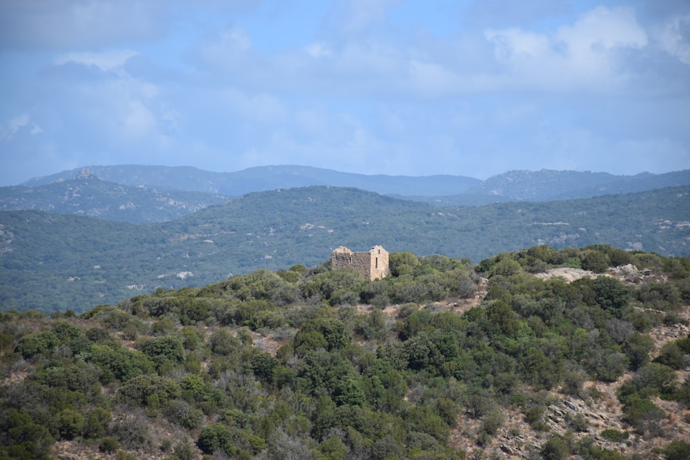 a building on top of a hill surrounded by trees