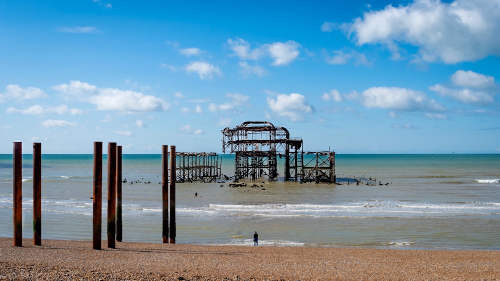 a large structure sitting on top of a beach next to the ocean