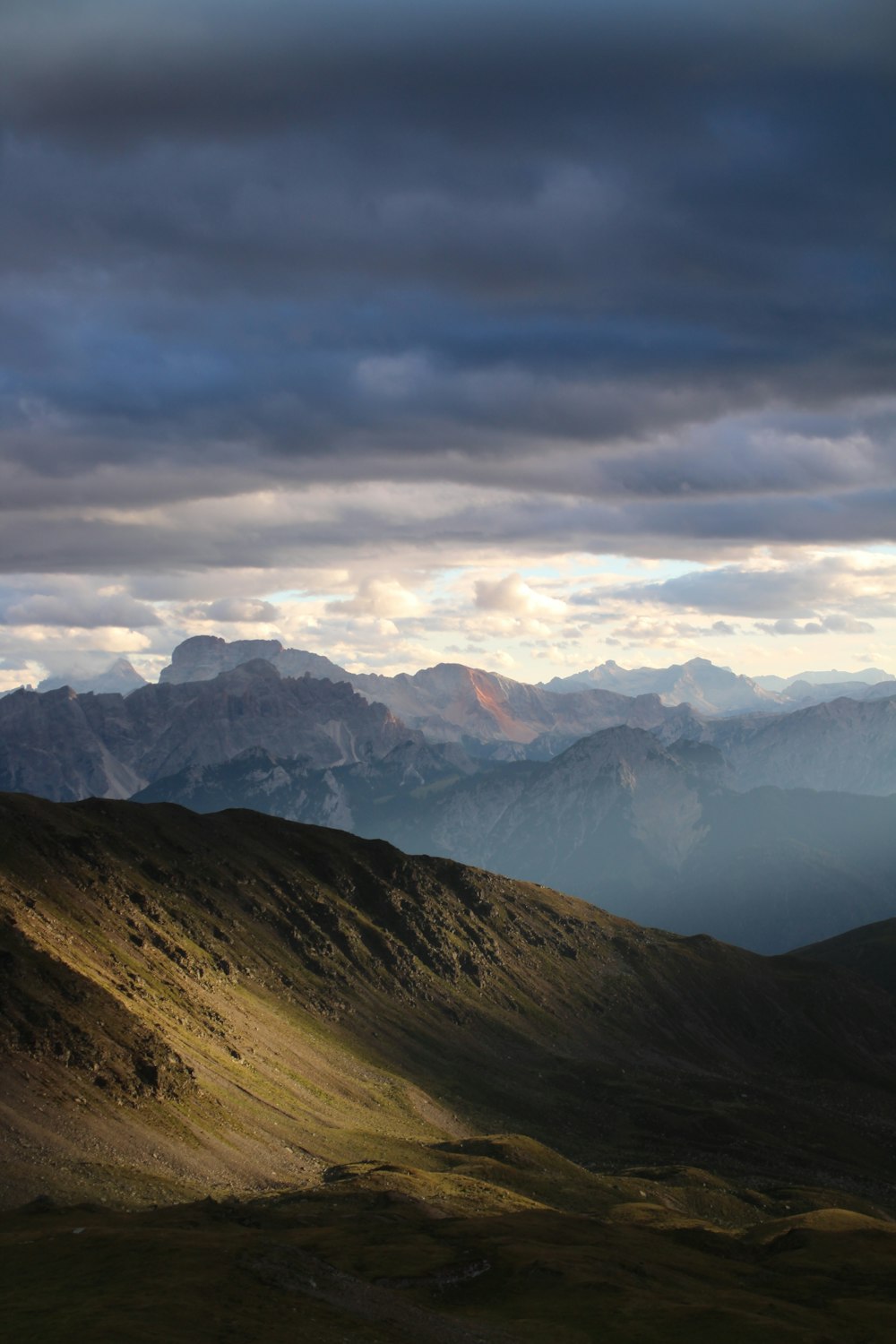 a view of a mountain range under a cloudy sky