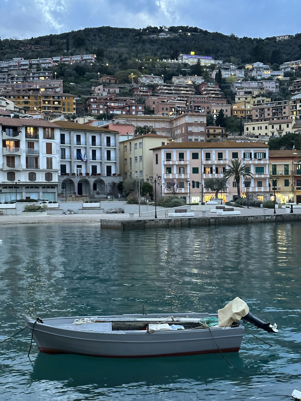 a small boat floating on top of a body of water