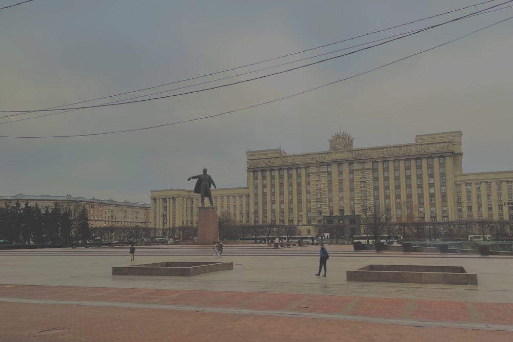 a statue of a man standing in front of a building