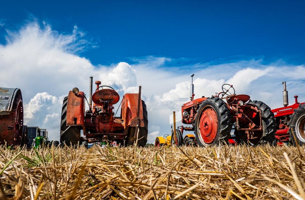 a row of farm tractors parked in a field