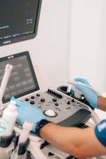 a person in blue gloves is operating a machine