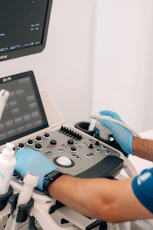 a person in blue gloves is operating a machine