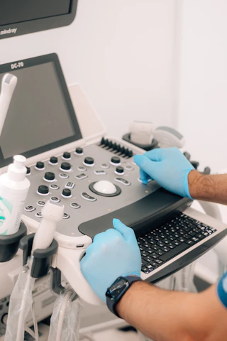 a person in blue gloves is operating a machine