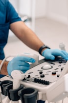 Veterinario ajustando ecógrafo con guantes, preparado para estudio diagnóstico