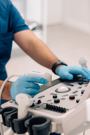 A technician carefully preparing an ultrasound machine for a patient at Rizvi Diagnostics.
