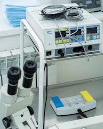 a medical machine with two microscopes on top of it