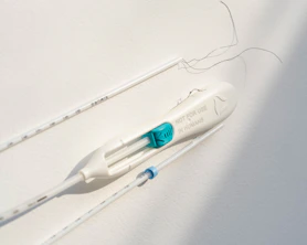 two toothbrushes are attached to a white wall