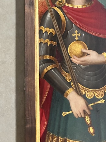 A powerful warrior lifting a massive golden staff glowing with mystical energy.