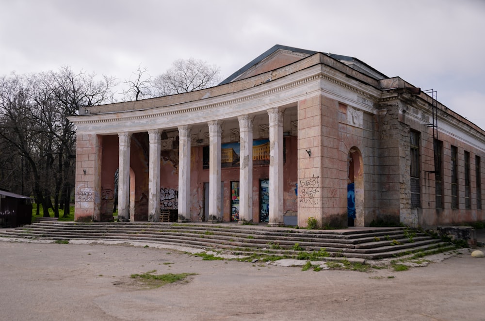 an old building with columns and steps leading up to it