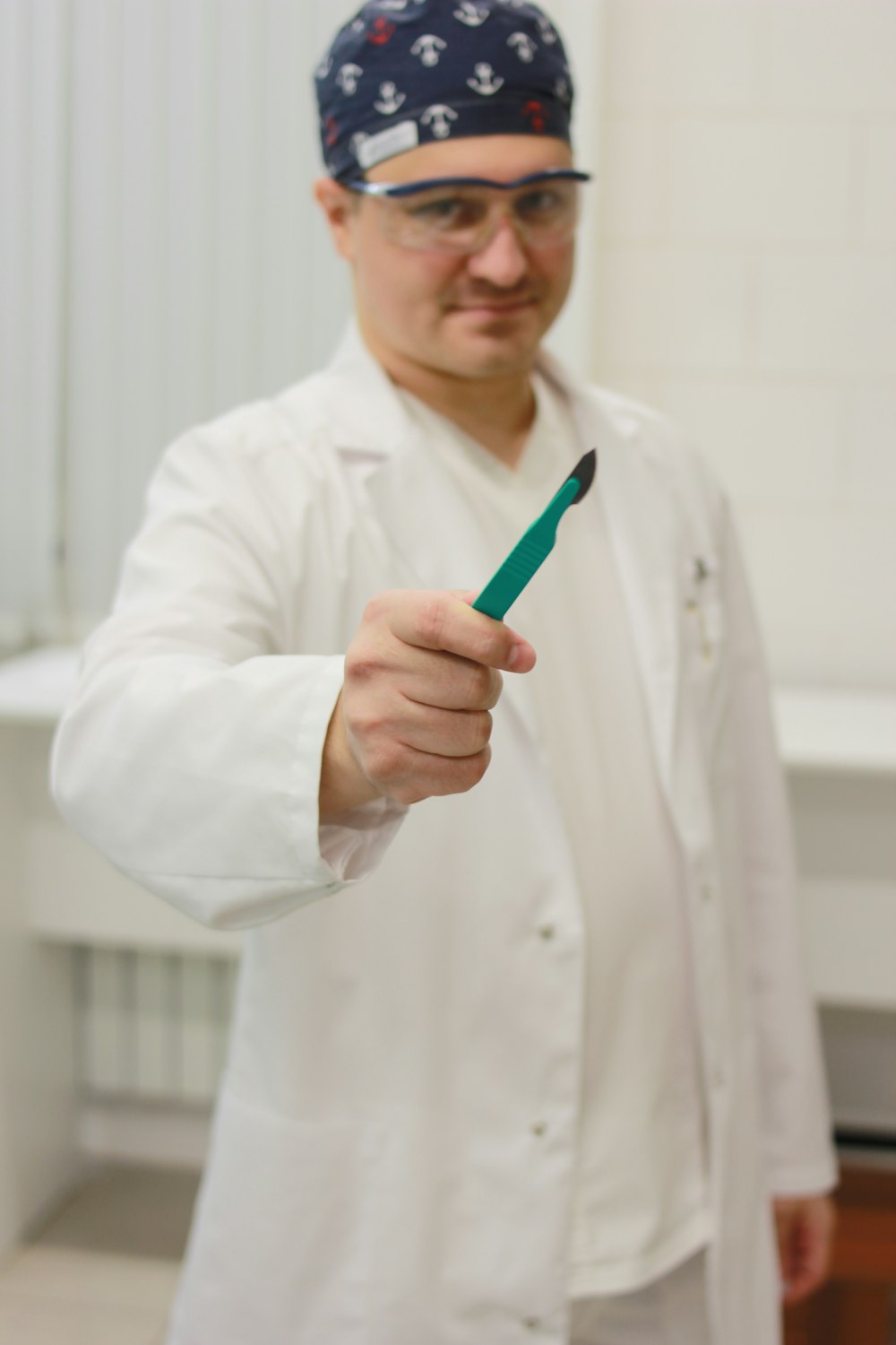 a man in a lab coat holding a toothbrush