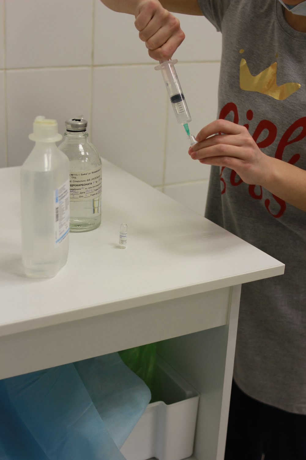 a person is holding a bottle of water and a tube of liquid