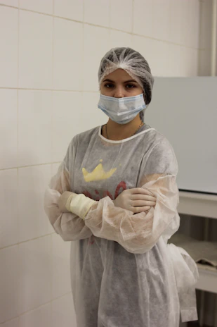 a woman wearing a surgical mask and gloves