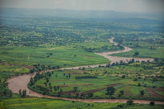 a river running through a lush green countryside