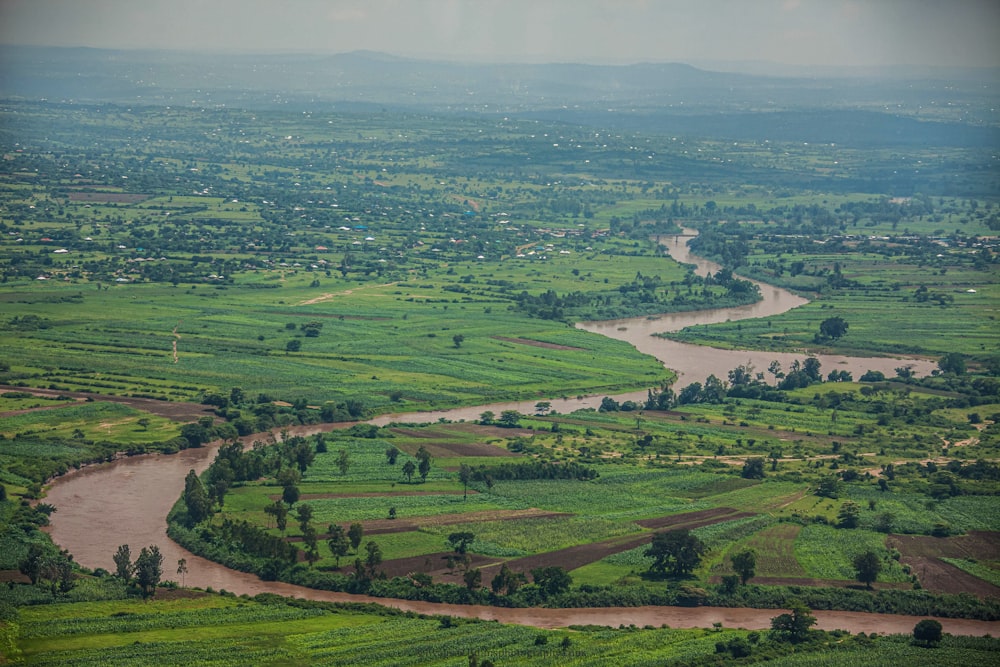 a river running through a lush green countryside