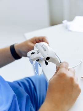A person is holding a white, handheld device labeled 'Gorelax'. The device appears to be some sort of electronic gadget, possibly for personal use.