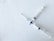 Two syringes intersect at right angles on a white textured surface. Each syringe has clear measurements visible and features a blue valve at the intersection point.