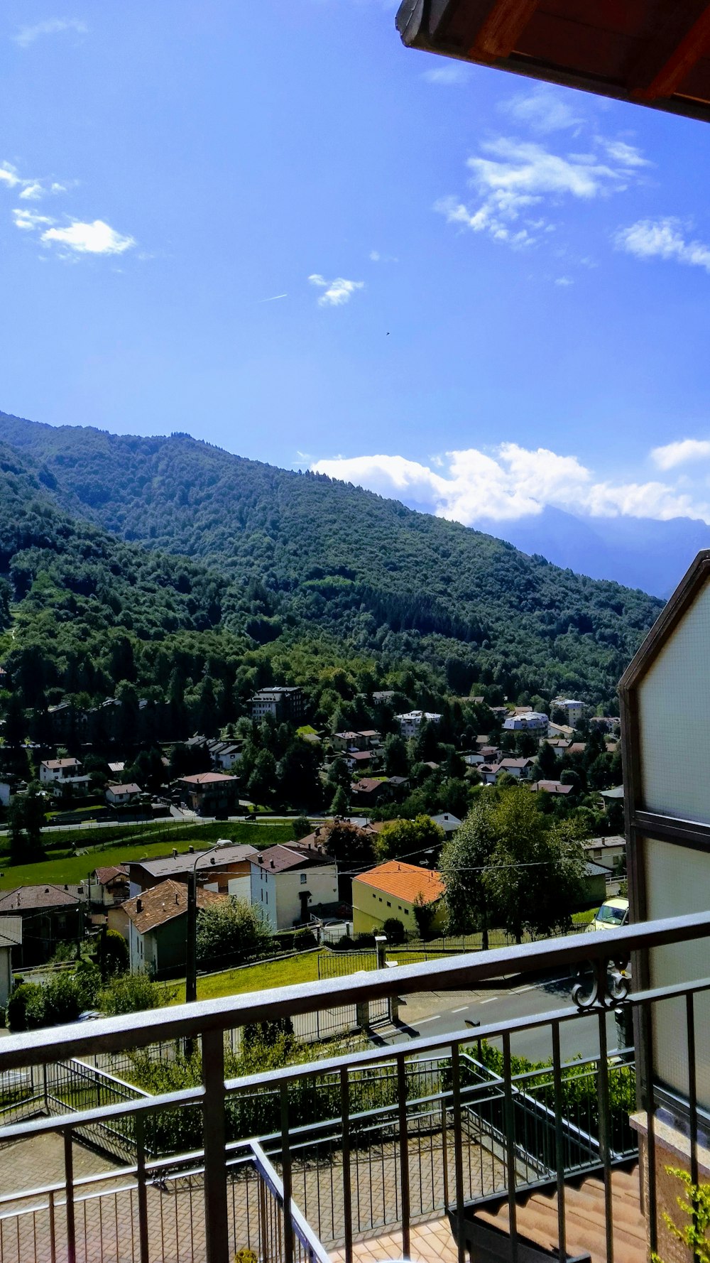 a balcony with a view of a town and mountains