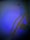 A ceiling fan with a protective grille is casting a shadow against a wall. The room is dimly lit with a blue hue, creating a calming and moody atmosphere.