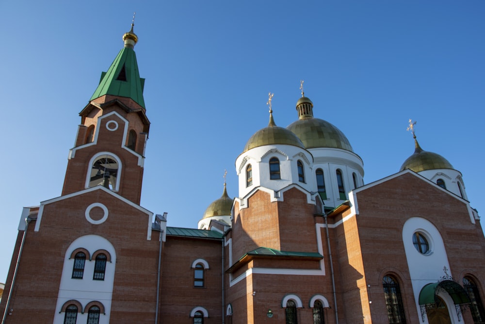 a large building with two towers and a green roof