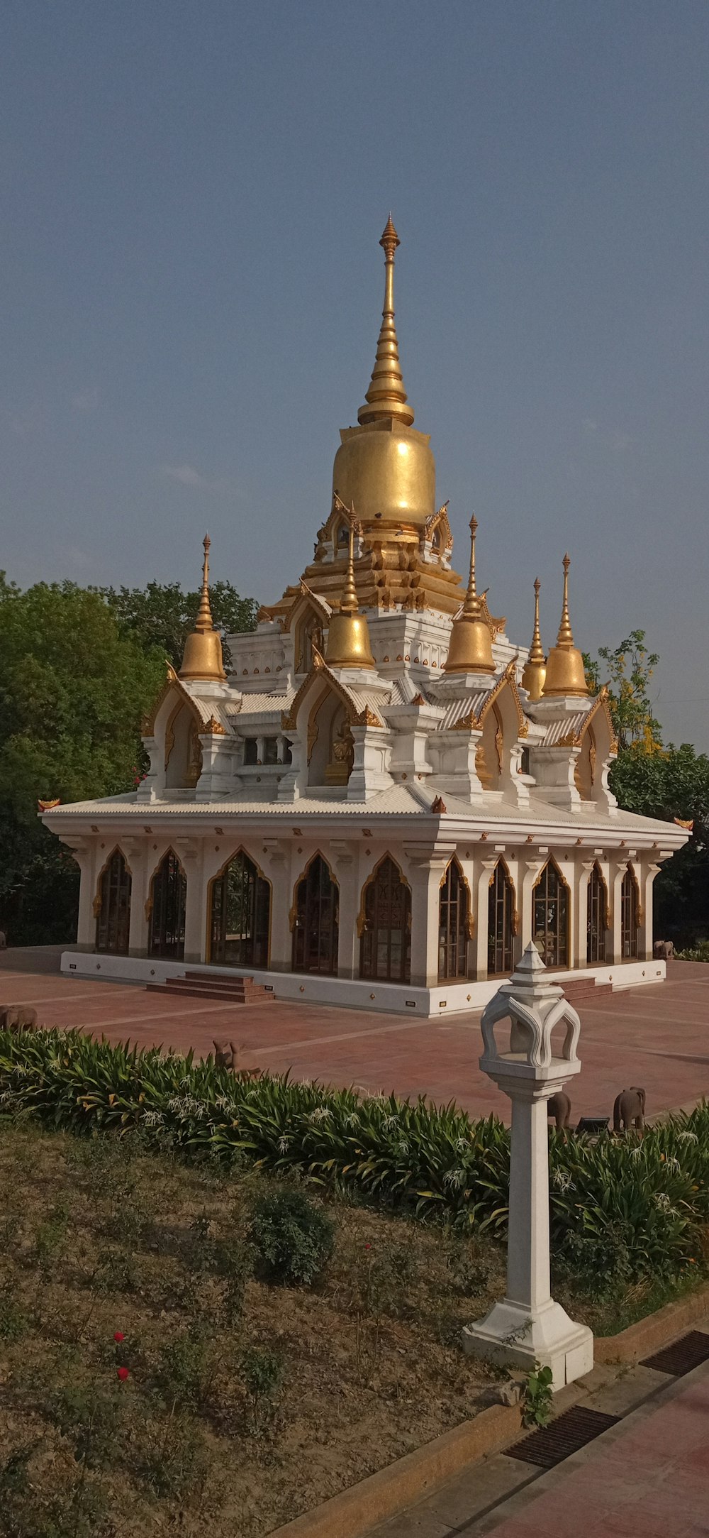 a large white and gold building sitting in a park