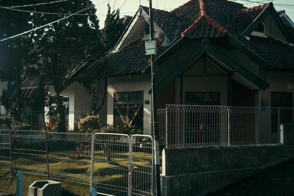 a house with a fence and a gate in front of it