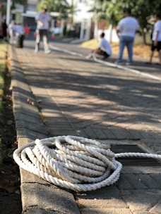 A small group gathered around a table learning rope splicing techniques.