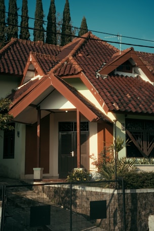 a white and brown house with a red roof