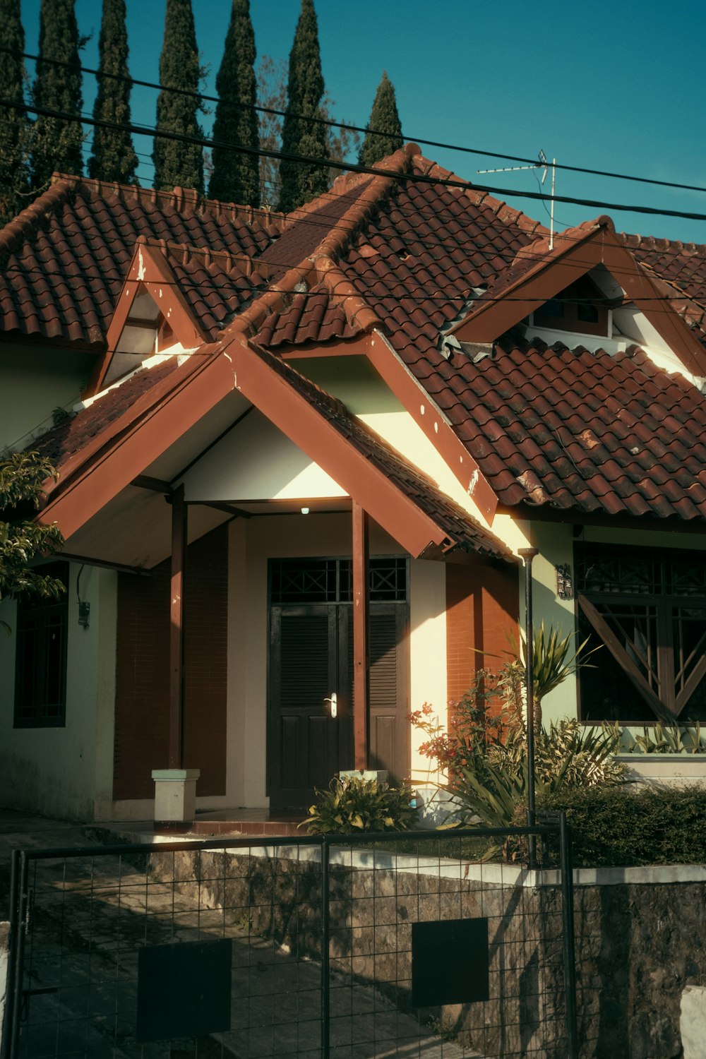 a white and brown house with a red roof