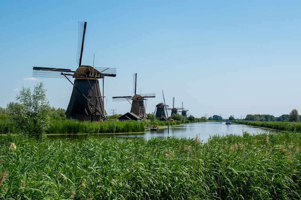 a row of windmills sitting next to a river